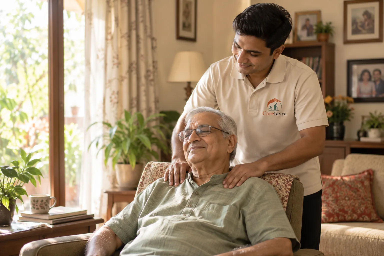 Caretavya caregiver with an elderly man relaxing in his armchair