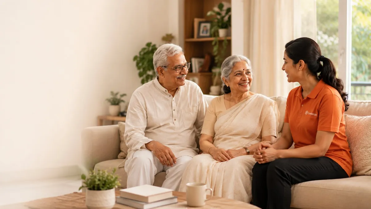 A Caretavya caregiver sitting warmly with an elderly couple at home